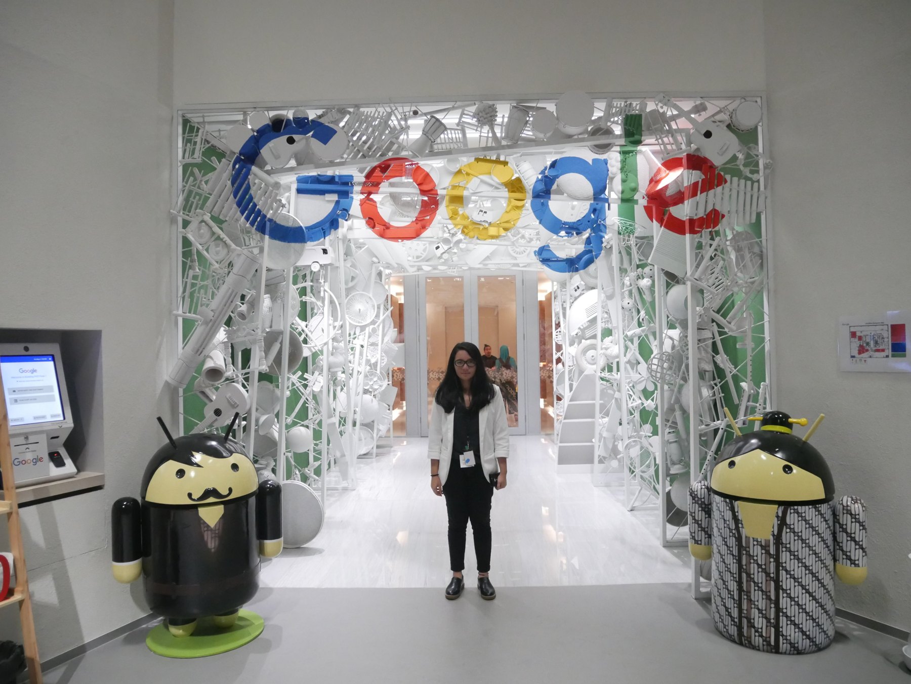 Agni standing beneath the Google sign during a visit